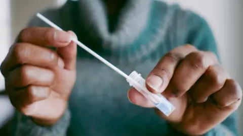 Shop-bought health testing kits 'inaccurate and unsuitable', study says Getty Images Anonymous shot of a person wearing a green polo neck jumper and holding a plastic test tube and a pipette.