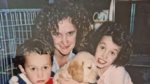 'We suffered bullying, anorexia and being branded as thieves' Millie Castleton Millie Castleton (R) aged eight, with mother and brother, and holding a labrador puppy