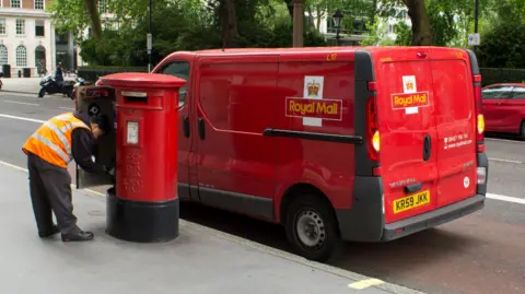 Royal Mail given go-ahead to scrap second-class post on Saturdays Getty Images A Royal Mail post van next to a post box where a postal worker is emptying letters
