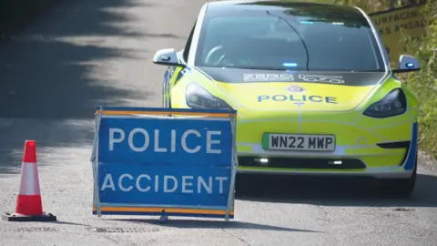 Amazon delivery driver dies as train strikes van in Teynham BBC A police car next to a Police Accident sign, which is blue