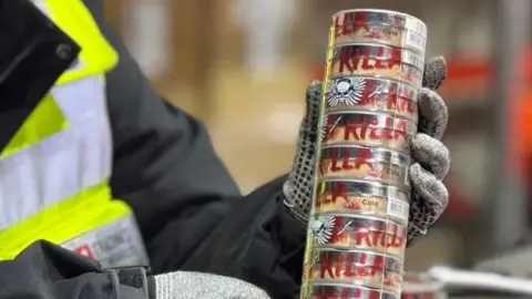 The rising use of nicotine pouches snus Kent Trading Standards Gloved hands hold a stack of tubs of nicotine pouches labelled with the word Killa