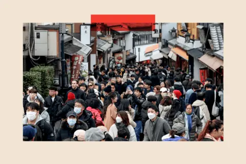 How Japan's far right was supercharged by Trump and tourists Getty Images Busy crowds of tourists holding up phones and wearing Covid masks on a narrow, crowded street