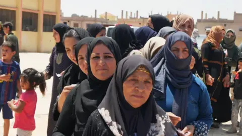 Bedouins tell BBC they could return to fighting Druze Displaced bedouin women wait for aid