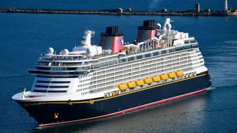 Father jumps from Disney cruise to save child who fell overboard Getty Images The Disney Dream cruise ship seen in the water. It has a waterslide on top and has 14 decks