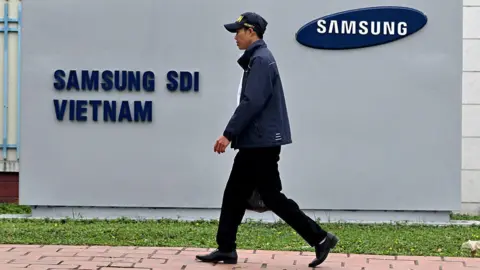 Asia is reeling but is anyone winning? Getty Images This photo taken on April 8, 2025 shows a man in a cap walking past the logo of Samsung Electronics on a billboard in Vietnam's Bac Ninh province.