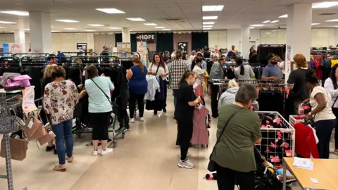 Hard-hit families hail £1 school uniform sale in Wigan Jasmine DuFraisse/BBC Shoppers at the £1school uniform sale