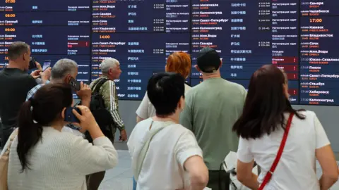 Moscow airports temporarily closed after Ukraine drone attacks EPA/Shutterstock Passengers examine departure table waiting their flights at Sheremetyevo International Airport outside Moscow, Russia, 07 July 2025.