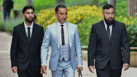 Jury shown CCTV of alleged assault on police at Manchester airport PA Media Human Rights lawyer Aamer Anwar (centre) arrives with Mohammed Fahir Amaaz (left) and Muhammed Amaad (right) at Liverpool Crown Court, where they are charged in relation to an altercation with police officers at Manchester Airport's Terminal Two on July 23 2024.