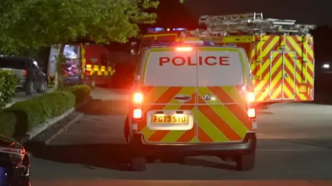 Teenage boy found dead in Sutton Park lake BBC The rear of a police van in a car park with yellow and orange chevrons on the back and its lights flashing with a fire engine behind it