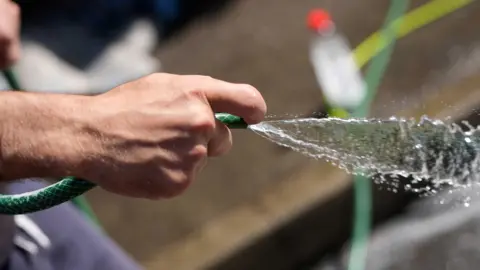 Southern Water issues hosepipe ban for Hampshire and Isle of Wight Getty Images A hand holding a green hosepipe with water flowing out of it.