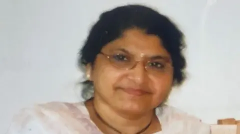 Victim's relative 'can't be at peace' until root cause known Family handout An older looking woman is seen in closeup. She wears earrings, and has dark hair and glasses.