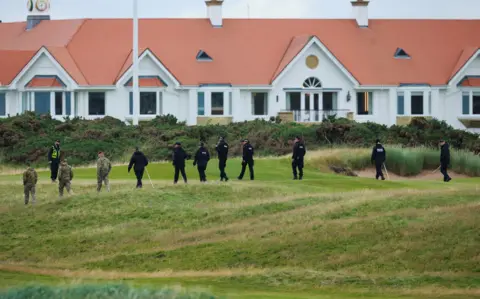Security tightens as Donald Trump plays golf at Turnberry Reuters A line of military personnel and police sweep a stretch of grass outside the luxury Turnberry resort