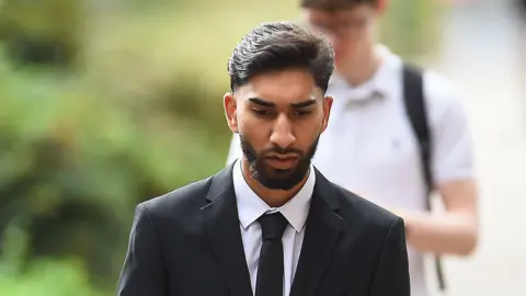 Jury shown CCTV of alleged assault on police at Manchester airport PA Media Mohammed Fahir Amaaz arrives at Liverpool Crown Court, where along with Muhammed Amaad they are charged in relation to an altercation with police officers at Manchester Airport's Terminal Two on July 23 2024.