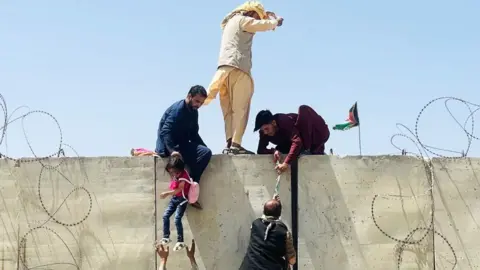 What we do and do not know Getty Images Afghans scaling a wall to access Kabul airport during the evacuation in 2021