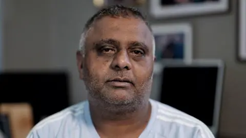 'I need someone to be punished' BBC Former sub-postmaster Harjinder Butoy sitting on a chair at his home in Chesterfield