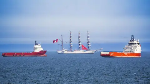 'Party city' event gets under sail PA Media Tall ship BAP Union, flanked by two offshore industry vessels, under a blue sky.