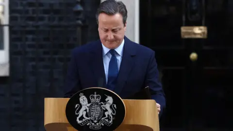 Julian Smith says David Cameron was 'cavalier' in handling of Brexit Getty Images David Cameron is standing in front of a podium that's been put up outside Number 10 Downing Street. He's wearing a navy suit and looking down.