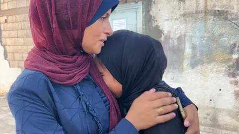 Gaza aid site offered a 'women only' day. It didn't stop the killing Mary Sheikh al-Eid's daughter, Warshazat (R), is comforted after her body is brought to Nasser Hospital in Khan Younis, southern Gaza (24 July 2025)
