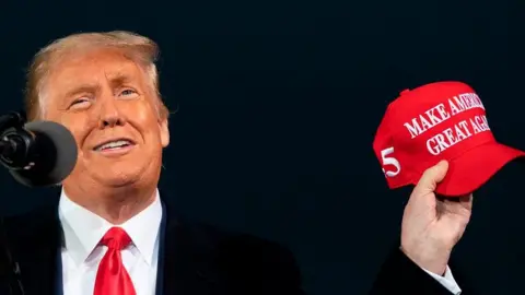 The secret of the perfect political slogan Getty Images US President Donald Trump holding a red baseball cap with the slogan Make America Great Again on it