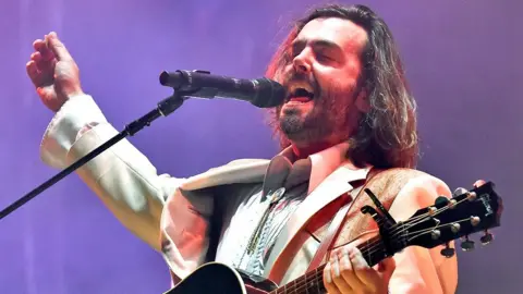 The 10-year-old song that keeps getting bigger Getty Images Lord Huron singer Ben Schneider on stage in a white suit with mouth open and eyes closed mid song, with one hand on a guitar neck and the other in the air. At the 2022 Bonnaroo Music & Arts festival in Tennessee.