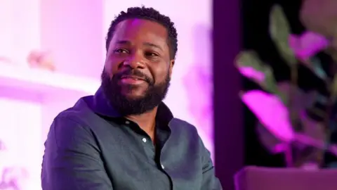 Malcolm-Jamal Warner, star of The Cosby Show, dies aged 54 Variety via Getty Images Malcolm-Jamal Warner sitting onstage in 2023. He is holding a microphone with the Variety logo on it.