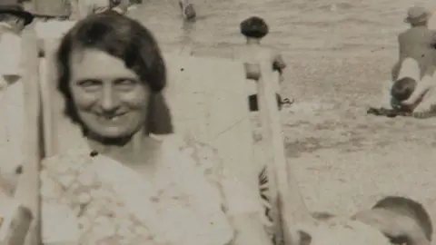 Cold case rapist and killer, 92, jailed for life Supplied Black and white photo of Louisa Dunne. She is sat on a deck chair looking at the camera and smiling.