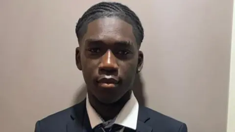 Teen jailed in Dubai for sex with girl is released Detained in Dubai Marcus Fakana in school uniform looks directly at the camera with his head against a grey backdrop.