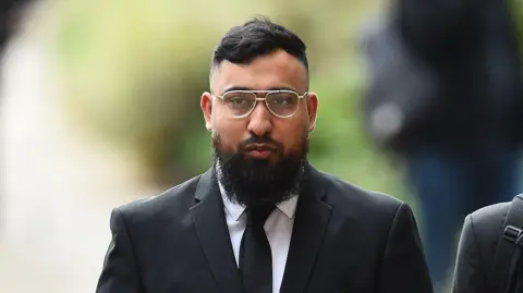 Jury shown CCTV of alleged assault on police at Manchester airport PA Media Muhammed Amaad arrives at Liverpool Crown Court, where along with Mohammed Fahir Amaaz they are charged in relation to an altercation with police officers at Manchester Airport's Terminal Two on July 23 2024.