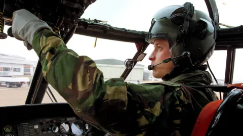 Military aircrew pursuing MoD after cancer diagnoses reaches 180 Getty Images Prince William in the cockpit of an aircraft. Is is wearing a helmet and a green and brown military camouflage flying suit .