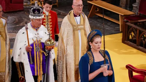 AI deepfake porn humiliated me, says Penny Mordaunt PA Media A newly-crowned King Charles III stands holding an orb and sceptre, while Penny Mordaunt, wearing a blue dress and hat, stands in front of him holding a sword with both hands. The sword is held upright in front of her face.