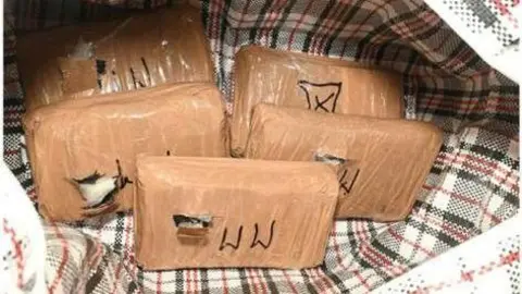'Gangsta Debbs' - the granny who used her family to run a drug gang Met Police Tightly packages of cocaine are placed into a tartan-style bag for life. Three of the five packages have been busted open to show a white powder coming out of it