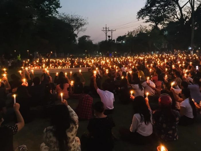 Myanmar candlelight vigil e1615191719790 Thousands Flee To India As Heavy Fighting In Myanmar Forces People To Seek Refuge In Neighboring Nation