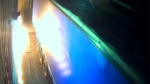 Why small-time criminals burned a London warehouse for Russia's mercenary group Wagner Metropolitan Police A security camera's view captured the fire at the warehouse as it licks towards the lorry in Leyton, east London