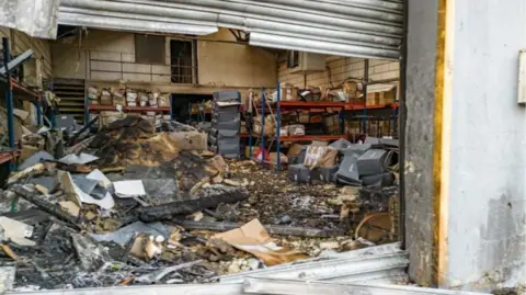 Why small-time criminals burned a London warehouse for Russia's mercenary group Wagner Metropolitan Police An image underneath a metal shutter shows a burnt out warehouse