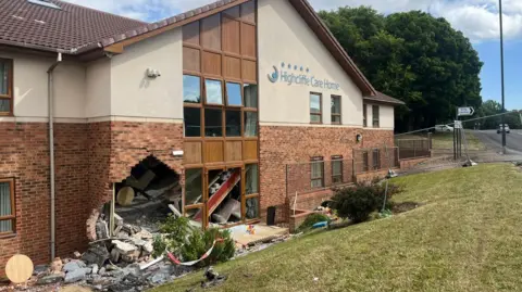 Arrests as Sunderland care home crash puts eight in hospital BBC A large hole at the bottom left of a brick and white stone building next to a window. Bricks and debris from the wall are scattered all around and in the bushes and grass in front of the building.