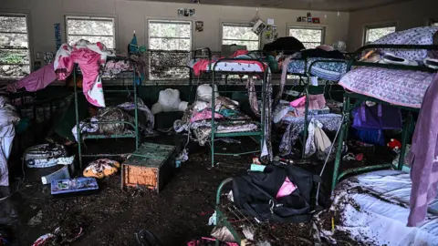 A girls' summer camp cut short by deadly disaster Getty Images Muddied bunk beds