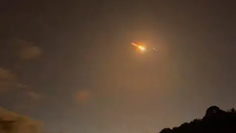 Pieces of asteroid may have landed across west Highlands, say experts @adriancoll1 A meteor burning across the night sky with a small dark patch of trees in the bottom right hand corner of the frame