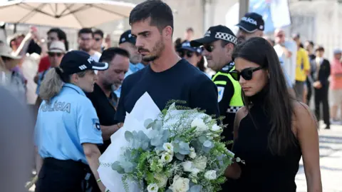 Crowds mourn Liverpool star Jota in his Portuguese hometown PA Media Andre Silva, football player at RB Leipzig and the Portuguese national team, and partner Maria Rodrigues attend a public wake held for Diogo Jota and his brother Andre Silva at the Capela da Ressurreicao.