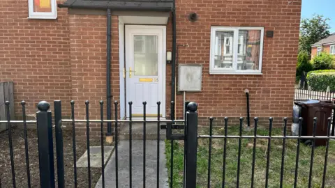 How did no-one know about mum and daughter's death for months? The front of the house on Hartley Road where the pair lived. A white front door and black railings around the outside