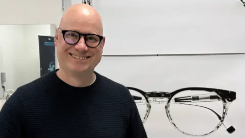 'Autofocus' specs promise sharp vision, near or far IXI Niko Eiden, smiling and wearing IXI's autofocus specs.