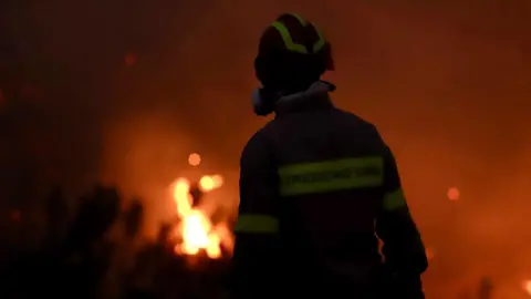mass evacuations as blaze rages near Ierapetra, Crete EPA A firefighter works at the scene of a wildfire in Ierapetra, on Crete island, Greece