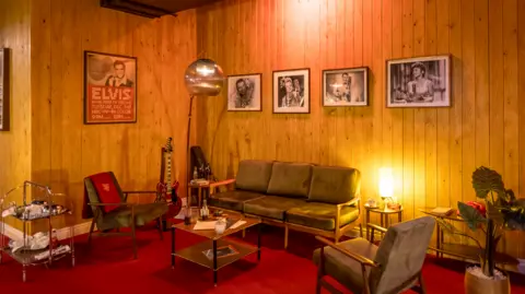 'Atrocious and misleading' show upsets some fans Graham Turner A room with green sofas and Elvis posters on the wall