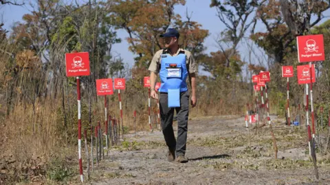 Prince Harry in Diana's footsteps with landmine walk in Angola PA Media Prince Harry following a path cleared in a minefield in Angola