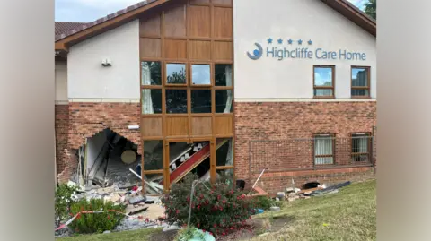 Arrests as Sunderland care home crash puts eight in hospital A brick and stone building with the sign reading 'Highcliffe Care Home' in blue writing. A large hole can be seen at the bottom left of the building next to a window. Bricks and debris from the wall are scattered all around and in the bushes and grass in front of the building.