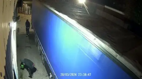 Why small-time criminals burned a London warehouse for Russia's mercenary group Wagner Metropolitan Police A man pours a green jerry can while another films him on a phone at the side of a lorry - all captured on security camera