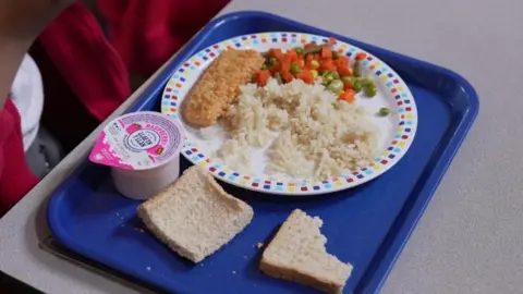 More price rises on the cards in Oxfordshire BBC A blue tray with a child's school dinner on it - there is a plate with rice, breaded fish and a vegetable medley. Two pieces of bread and a yoghurt are next to it.