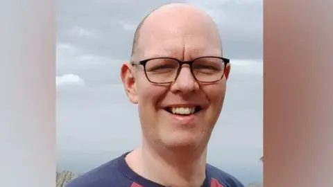 Man found guilty of 'Good Samaritan' murder South Yorkshire Police A headshot of Chris Marriott, who wears glasses and a navy t-shirt, smiling.