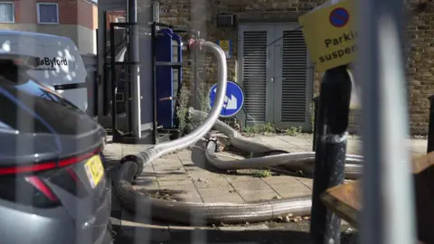 London heat network users say price cap lack has cost them dearly The network of North Peckham Heat Network pipes criss cross on the pavement in front of a boiler house