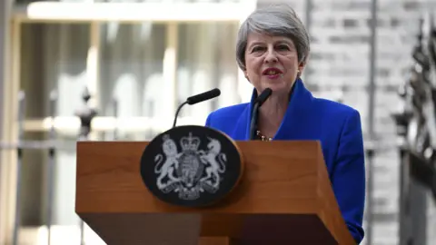 Julian Smith says David Cameron was 'cavalier' in handling of Brexit Getty Images Theresa May is standing in front of a mic on a podium outside 10 owning Street. She's wearing blue and talking to the media.
