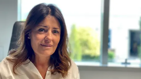 'The village will die' - Italy looks for answers to decline in number of babies Katia da Ros, a woman with dark hair in a white shirt